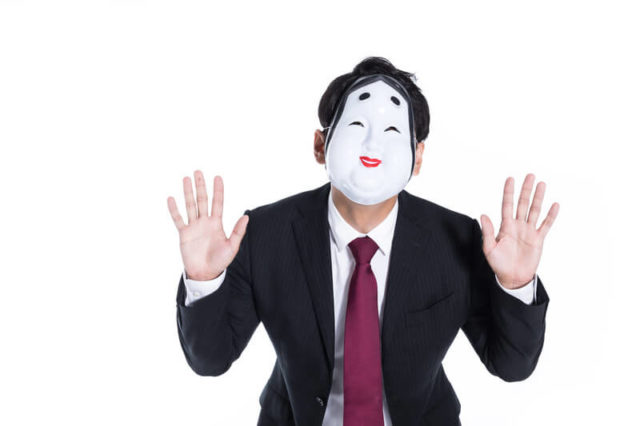 仮面をつける詐欺師
